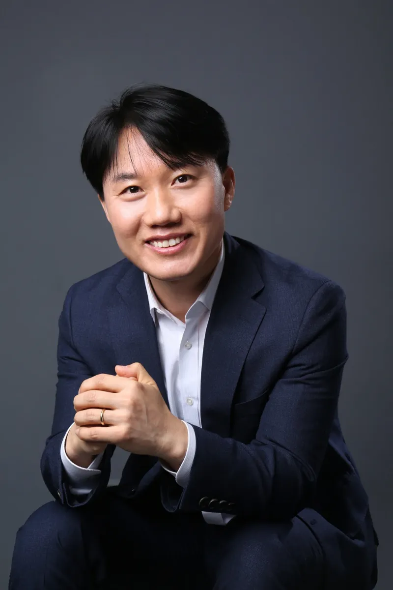 남색 정장을 입고 두 손을 모은 지병근 대표세무사